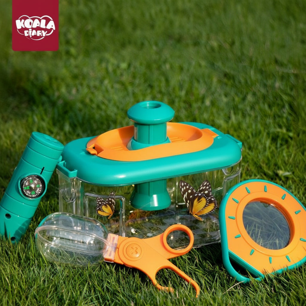 Outdoor exploration set with butterfly habitat and tools on grass, featuring Koala Diary branding.